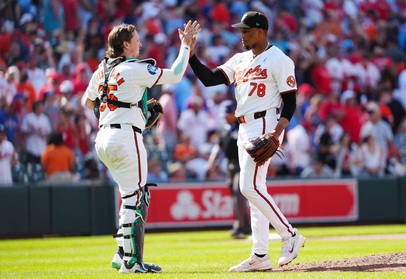 Jun 16, 2024; Baltimore, Maryland, USA; Baltimore Orioles catcher Adley Rutschman (35) and Baltimore Orioles pitcher Yennier Cano (78) slap hands to celebrate the victory against the Philadelphia Phillies after the ninth inning at Oriole Park at Camden Yards. Mandatory Credit: Gregory Fisher-USA TODAY Sports