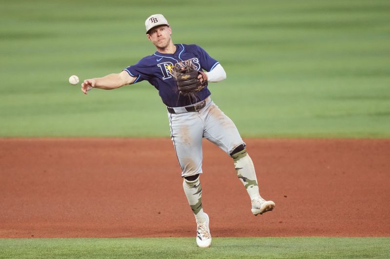 May 18, 2025; Miami, Florida, USA;  Tampa Bay Rays shortstop Taylor Walls (6) throws out Miami Marlins second baseman Otto Lopez (6) in the eighth inning at loanDepot Park. Mandatory Credit: Jim Rassol-Imagn Images
