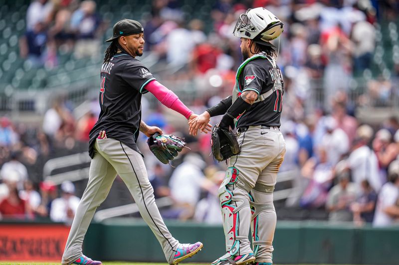 Jun 5, 2025; Cumberland, Georgia, USA; Arizona Diamondbacks second baseman Ketel Marte (4) reacts with catcher Jose Herrera (11) after the Diamondbacks defeated the Atlanta Braves at Truist Park. Mandatory Credit: Dale Zanine-Imagn Images