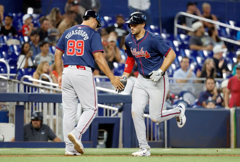 Sep 21, 2024; Miami, Florida, USA;  Atlanta Braves first baseman Matt Olson (28) celebrates with third base coach Matt Tuiasosopo (89) after hitting a home run against the Miami Marlins in the seventh inning at loanDepot Park. Mandatory Credit: Rhona Wise-Imagn Images