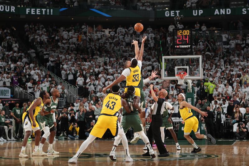 MILWAUKEE, WI - APRIL 23: Brook Lopez #11 of the Milwaukee Bucks and Myles Turner #33 of the Indiana Pacers go up for the opening tip off during the game during Round One Game Two of the 2024 NBA Playoffs on April 23, 2024 at the Fiserv Forum Center in Milwaukee, Wisconsin. NOTE TO USER: User expressly acknowledges and agrees that, by downloading and or using this Photograph, user is consenting to the terms and conditions of the Getty Images License Agreement. Mandatory Copyright Notice: Copyright 2024 NBAE (Photo by Gary Dineen/NBAE via Getty Images).