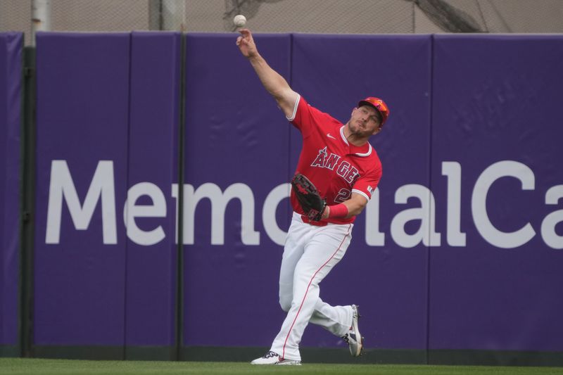 Mar 5, 2025; Tempe, Arizona, USA; Los Angeles Angels outfielder Mike Trout (27) makes the play for an out against the Los Angeles Dodgers in the second inning at Tempe Diablo Stadium. Mandatory Credit: Rick Scuteri-Imagn Images