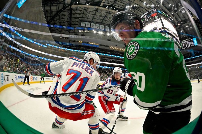 Nov 20, 2023; Dallas, Texas, USA; Dallas Stars defenseman Ryan Suter (20) and New York Rangers center Tyler Pitlick (71) look for the puck in the Rangers zone during the second period at the American Airlines Center. Mandatory Credit: Jerome Miron-USA TODAY Sports