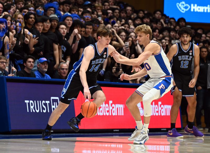 Dec 2, 2025; Durham, North Carolina, USA; Duke Blue Devils forward Nikolas Khamenia (14) controls the ball in front of Florida Gators forward Thomas Haugh (10) during the first half at Cameron Indoor Stadium. Mandatory Credit: Rob Kinnan-Imagn Images