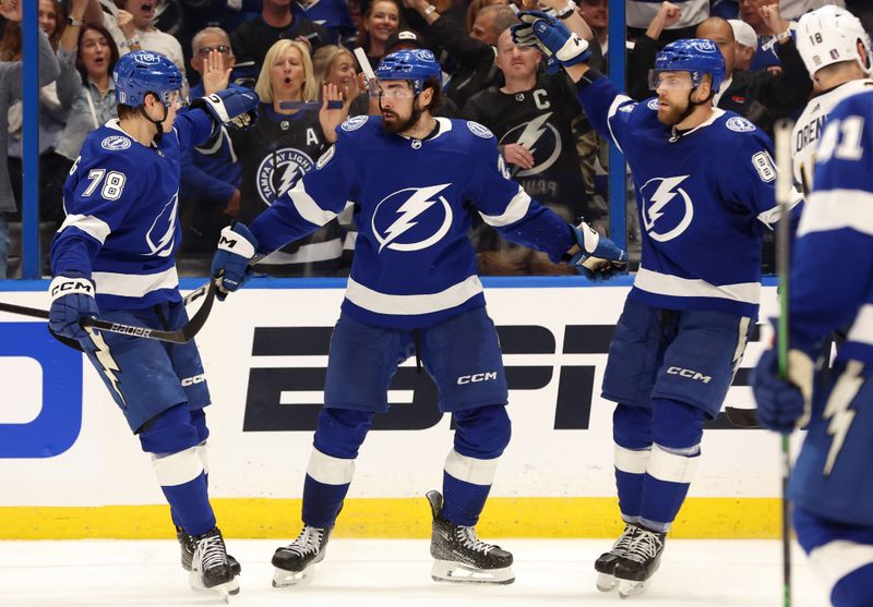 Apr 25, 2024; Tampa, Florida, USA; Tampa Bay Lightning left wing Nicholas Paul (20) is congratulated by defenseman Emil Lilleberg (78) and defenseman Erik Cernak (81) during the third period in game three of the first round of the 2024 Stanley Cup Playoffs at Amalie Arena. Mandatory Credit: Kim Klement Neitzel-USA TODAY Sports