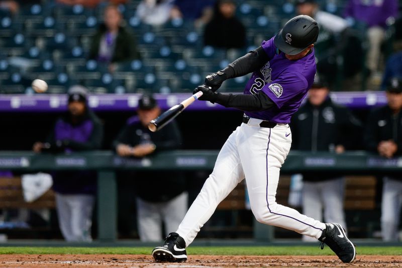 Apr 28, 2025; Denver, Colorado, USA; Colorado Rockies right fielder Mickey Moniak (22) hits a single in the fourth inning against the Atlanta Braves at Coors Field. Mandatory Credit: Isaiah J. Downing-Imagn Images