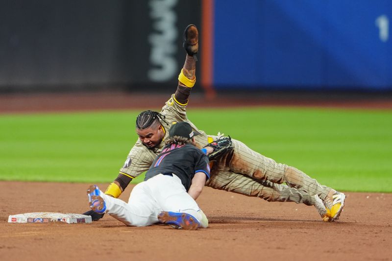 Jun 14, 2024; New York City, New York, USA; New York Mets second baseman Jeff McNeil (1) tags out San Diego Padres first baseman Luis Arraez (4) attempting to steal second base during the sixth inning at Citi Field. Mandatory Credit: Gregory Fisher-USA TODAY Sports