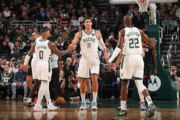 MILWAUKEE, WI - DECEMBER 17: Damian Lillard #0 of the Milwaukee Bucks high fives Brook Lopez #11 of the Milwaukee Bucks during the game against the Houston Rockets on December 17, 2023 at the Fiserv Forum Center in Milwaukee, Wisconsin. NOTE TO USER: User expressly acknowledges and agrees that, by downloading and or using this Photograph, user is consenting to the terms and conditions of the Getty Images License Agreement. Mandatory Copyright Notice: Copyright 2023 NBAE (Photo by Gary Dineen/NBAE via Getty Images). 