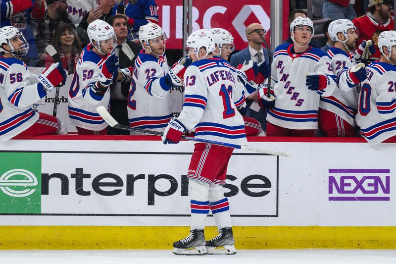 Feb 9, 2024; Chicago, Illinois, USA; New York Rangers left wing Alexis Lafreniere (13) celebrates his goal with teammates against the Chicago Blackhawks during the first period at the United Center. Mandatory Credit: Daniel Bartel-USA TODAY Sports