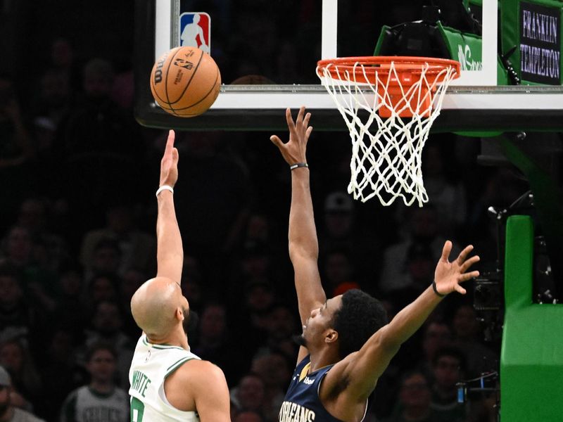 BOSTON, MASSACHUSETTS - JANUARY 29: Derrick White #9 of the Boston Celtics attempts a basket against Herbert Jones #5 of the New Orleans Pelicans during the fourth quarter at the TD Garden on January 29, 2024 in Boston, Massachusetts. NOTE TO USER: User expressly acknowledges and agrees that, by downloading and or using this photograph, User is consenting to the terms and conditions of the Getty Images License Agreement. (Photo by Brian Fluharty/Getty Images)