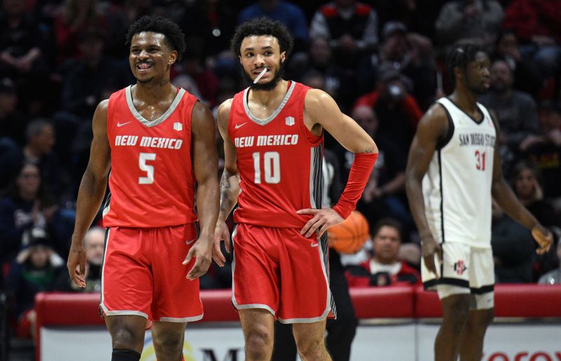 Jan 14, 2023; San Diego, California, USA; New Mexico Lobos guard Jamal Mashburn Jr. (5) and guard Jaelen House (10) look on ahead of San Diego State Aztecs forward Nathan Mensah (31) during the first half at Viejas Arena. Mandatory Credit: Orlando Ramirez-USA TODAY Sports