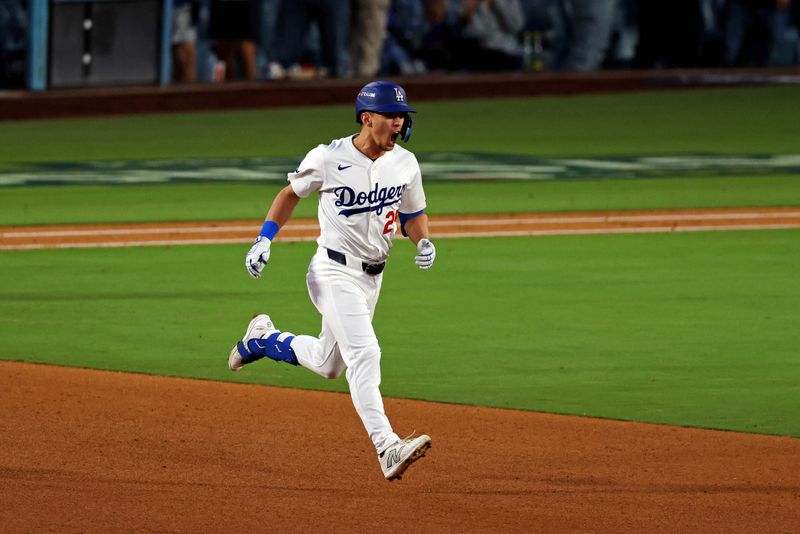 Oct 20, 2024; Los Angeles, California, USA; Los Angeles Dodgers outfielder Tommy Edman (25) celebrates after hitting a two run home run during the third inning against the New York Mets during game six of the NLCS for the 2024 MLB playoffs at Dodger Stadium. Mandatory Credit: Jason Parkhurst-Imagn Images