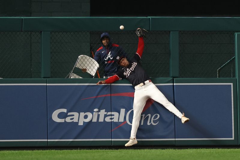 Sep 16, 2025; Washington, District of Columbia, USA; Washington Nationals outfielder Daylen Lile (51) attempts to catch a double hit by Atlanta Braves outfielder Michael Harris II (not pictured) during the seventh inning at Nationals Park. Mandatory Credit: Geoff Burke-Imagn Images