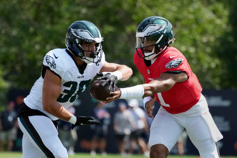 Philadelphia Eagles quarterback Jalen Hurts (1) hands off to running back Will Shipley (39) during a joint NFL football practice with the New England Patriots, Tuesday, Aug. 13, 2024, in Foxborough, Mass. (AP Photo/Michael Dwyer)