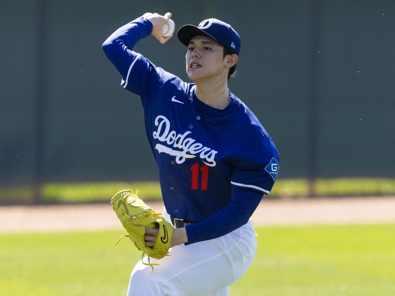 Feb 25, 2025; Phoenix, Arizona, USA; Los Angeles Dodgers pitcher Roki Sasaki (11) during workouts at Camelback Ranch-Glendale. Mandatory Credit: Mark J. Rebilas-Imagn Images