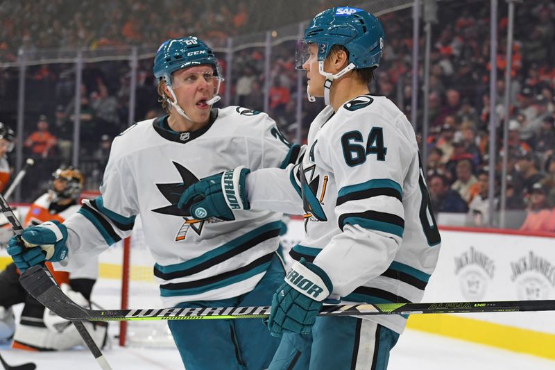 Nov 11, 2024; Philadelphia, Pennsylvania, USA; San Jose Sharks center Mikael Granlund (64) celebrates his goal with  left wing Fabian Zetterlund (20) against Philadelphia Flyers during the second period at Wells Fargo Center. Mandatory Credit: Eric Hartline-Imagn Images