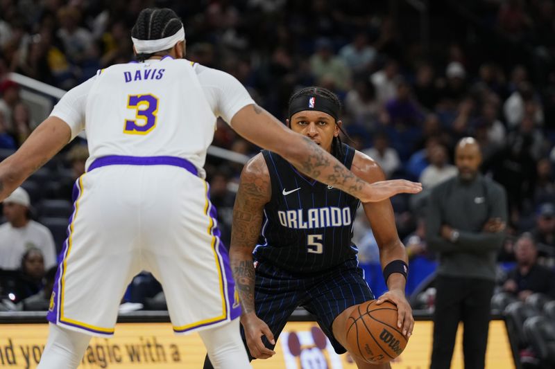 ORLANDO, FLORIDA - NOVEMBER 04: Paolo Banchero #5 of the Orlando Magic looks to dribble past Anthony Davis #3 of the Los Angeles Lakers during the second half at Amway Center on November 04, 2023 in Orlando, Florida. NOTE TO USER: User expressly acknowledges and agrees that, by downloading and or using this photograph, User is consenting to the terms and conditions of the Getty Images License Agreement. (Photo by Rich Storry/Getty Images)