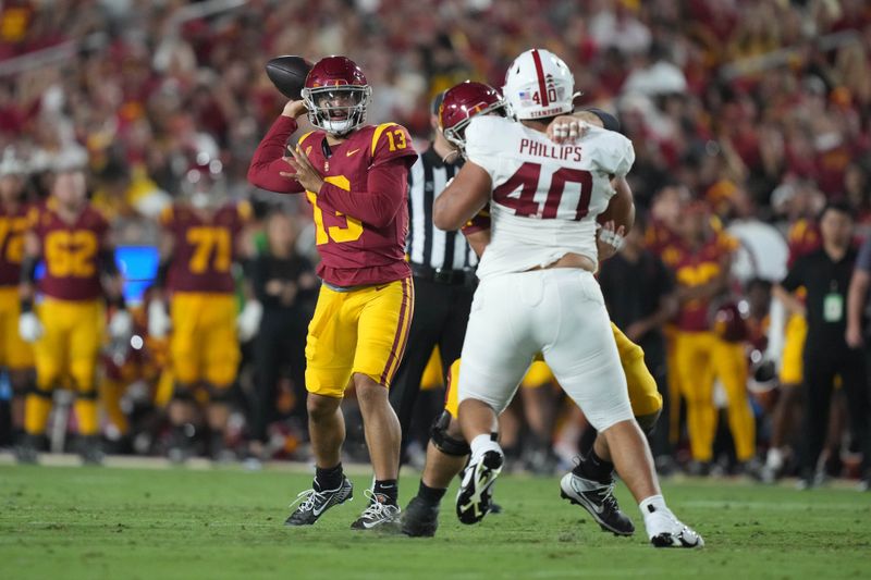 Sep 9, 2023; Los Angeles, California, USA; Southern California Trojans quarterback Caleb Williams (13) throws the ball against Stanford Cardinal defensive lineman Tobin Phillips (40) in the first half at United Airlines Field at Los Angeles Memorial Coliseum. Mandatory Credit: Kirby Lee-USA TODAY Sports