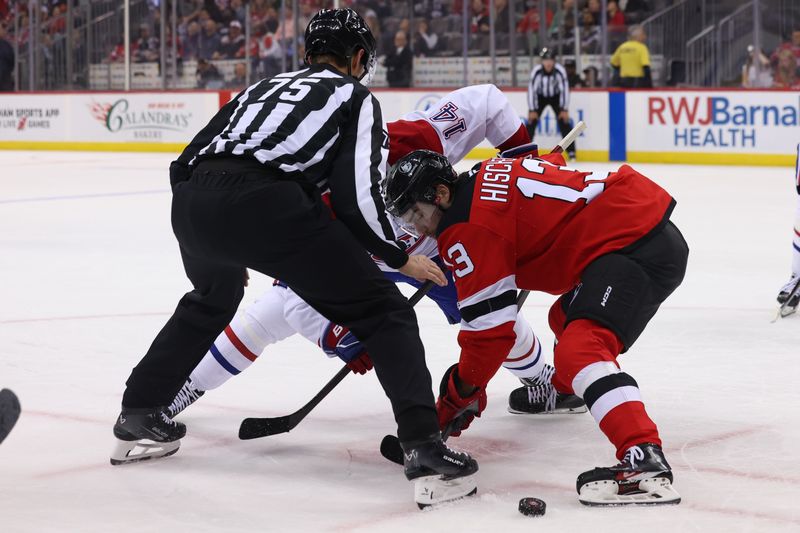 Nov 7, 2024; Newark, New Jersey, USA; New Jersey Devils center Nico Hischier (13) and Montreal Canadiens center Nick Suzuki (14) face-off during the first period at Prudential Center. Mandatory Credit: Ed Mulholland-Imagn Images