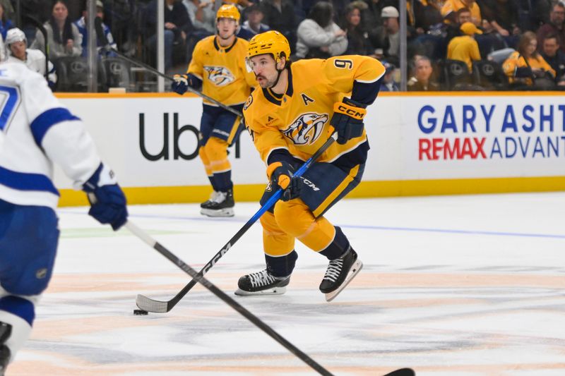 Oct 28, 2025; Nashville, Tennessee, USA;  Nashville Predators left wing Filip Forsberg (9) skates with the puck against the Tampa Bay Lightning during the second period at Bridgestone Arena. Mandatory Credit: Steve Roberts-Imagn Images