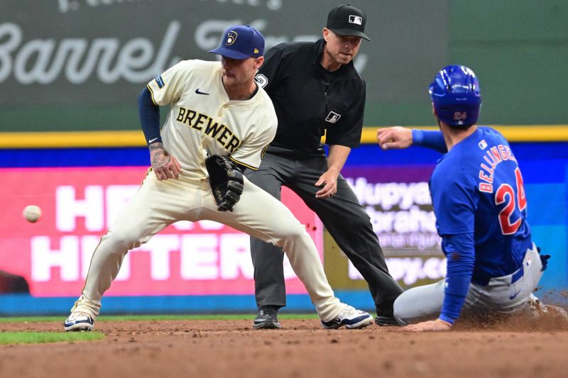 May 29, 2024; Milwaukee, Wisconsin, USA; Chicago Cubs center fielder Cody Bellinger (24) steals second base before tag by Milwaukee Brewers second baseman Brice Turang (2) in the third inning at American Family Field. Mandatory Credit: Benny Sieu-USA TODAY Sports