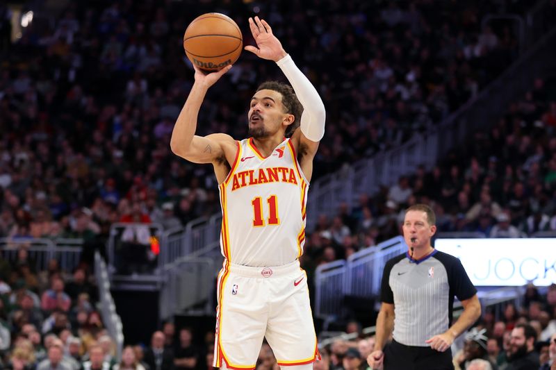 MILWAUKEE, WISCONSIN - DECEMBER 02: Trae Young #11 of the Atlanta Hawks takes a three point shot during the second half of a game against the Milwaukee Bucks at Fiserv Forum on December 02, 2023 in Milwaukee, Wisconsin. NOTE TO USER: User expressly acknowledges and agrees that, by downloading and or using this photograph, User is consenting to the terms and conditions of the Getty Images License Agreement. (Photo by Stacy Revere/Getty Images)