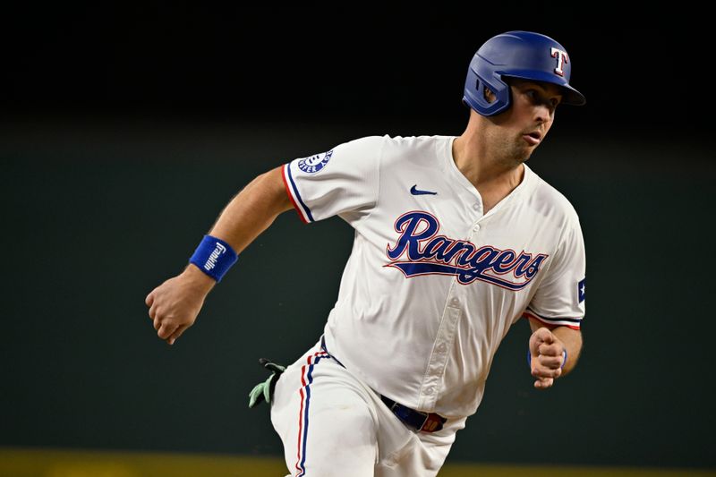 Sep 17, 2024; Arlington, Texas, USA; Texas Rangers first baseman Nathaniel Lowe (30) scores against the Toronto Blue Jays during the sixth inning at Globe Life Field. Mandatory Credit: Jerome Miron-Imagn Images