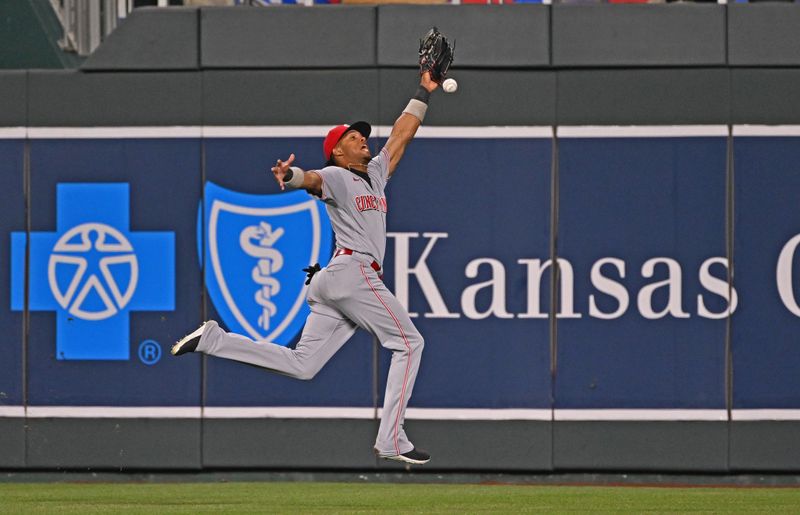 Jun 14, 2023; Kansas City, Missouri, USA;  Cincinnati Reds center fielder Jose Barrero (2) makes an attempt to catch a triple hit by Kansas City Royals center fielder Dairon Blanco (not pictured) in the eighth inning at Kauffman Stadium. Mandatory Credit: Peter Aiken-USA TODAY Sports