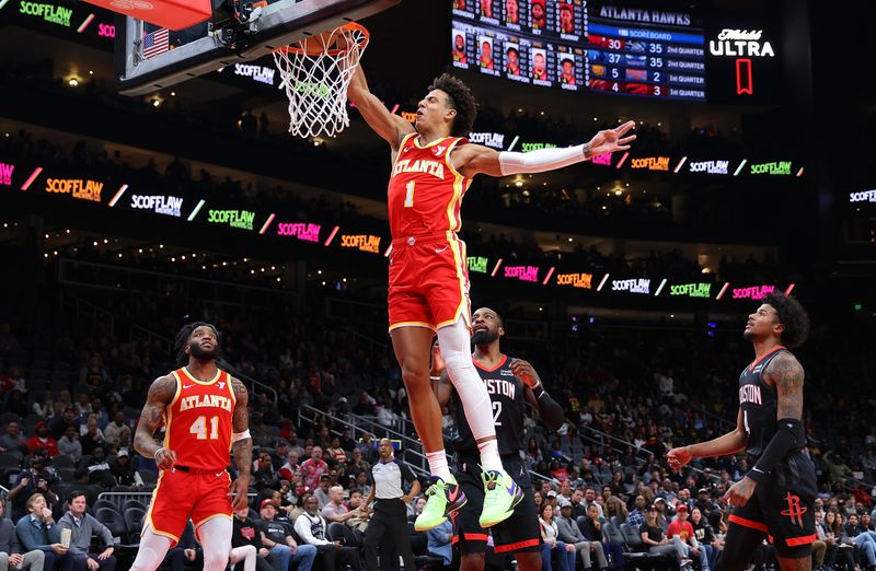 ATLANTA, GEORGIA - FEBRUARY 10:  Jalen Johnson #1 of the Atlanta Hawks dunks against Jeff Green #32 and Jalen Green #4 of the Houston Rockets during the first quarter at State Farm Arena on February 10, 2024 in Atlanta, Georgia.  NOTE TO USER: User expressly acknowledges and agrees that, by downloading and/or using this photograph, user is consenting to the terms and conditions of the Getty Images License Agreement.  (Photo by Kevin C. Cox/Getty Images)