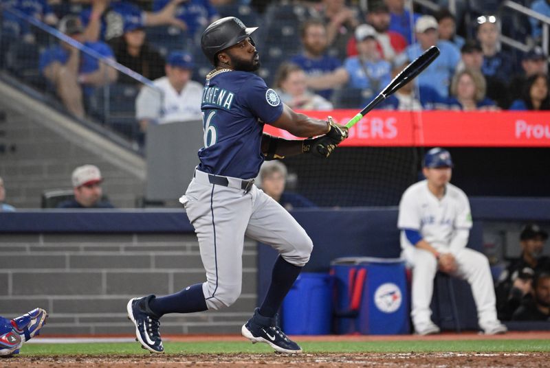 Apr 19, 2025; Toronto, Ontario, CAN;  Seattle Mariners left fielder Randy Arozarena (56) hits an RBI single against the Toronto Blue Jays in the 12th inning at Rogers Centre. Mandatory Credit: Dan Hamilton-Imagn Images
