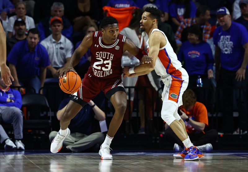 Jan 25, 2023; Gainesville, Florida, USA; South Carolina Gamecocks forward Gregory Jackson II (23) dribbles against Florida Gators guard Myreon Jones (0) during the second half at Exactech Arena at the Stephen C. O'Connell Center. Mandatory Credit: Kim Klement-USA TODAY Sports