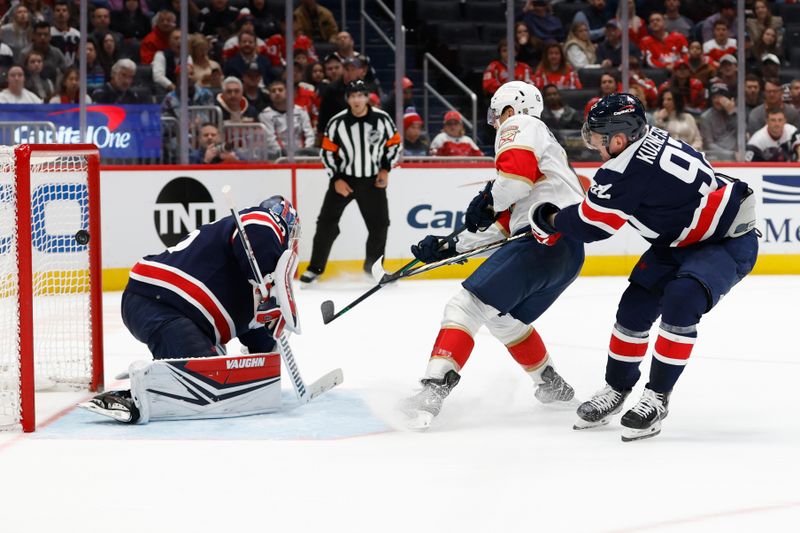 Nov 8, 2023; Washington, District of Columbia, USA; Florida Panthers center Sam Reinhart (13) scores the game winning goal on Washington Capitals goaltender Darcy Kuemper (35) as Capitals center Evgeny Kuznetsov (92) defends in overtime at Capital One Arena. Mandatory Credit: Geoff Burke-USA TODAY Sports