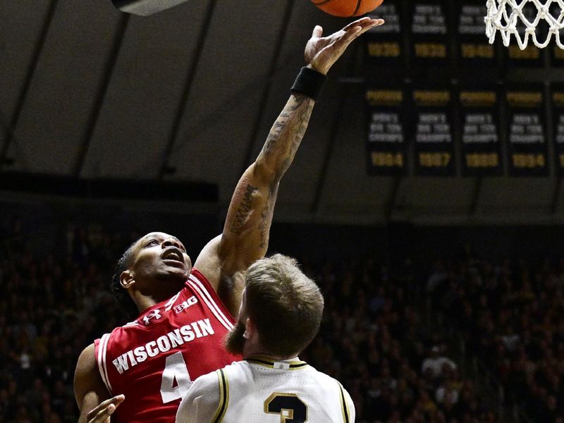 Feb 15, 2025; West Lafayette, Indiana, USA; Wisconsin Badgers guard Kamari McGee (4) shoots the ball in front of Purdue Boilermakers guard Braden Smith (3) during the first half at Mackey Arena. Mandatory Credit: Marc Lebryk-Imagn Images