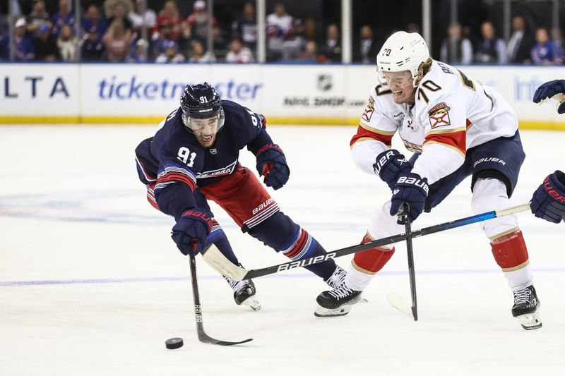 Oct 24, 2024; New York, New York, USA;  New York Rangers right wing Reilly Smith (91) and Florida Panthers center Jesper Boqvist (70) battle for control of the puck in the third period at Madison Square Garden. Mandatory Credit: Wendell Cruz-Imagn Images