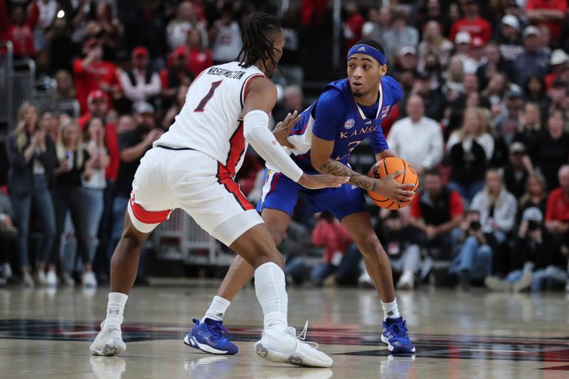 Jan 3, 2023; Lubbock, Texas, USA;  Kansas Jayhawks guard Dajuan Harris Jr (3) looks to pass the ball against Texas Tech Red Raiders guard Lamar Washington (1) in the second half at United Supermarkets Arena. Mandatory Credit: Michael C. Johnson-USA TODAY Sports