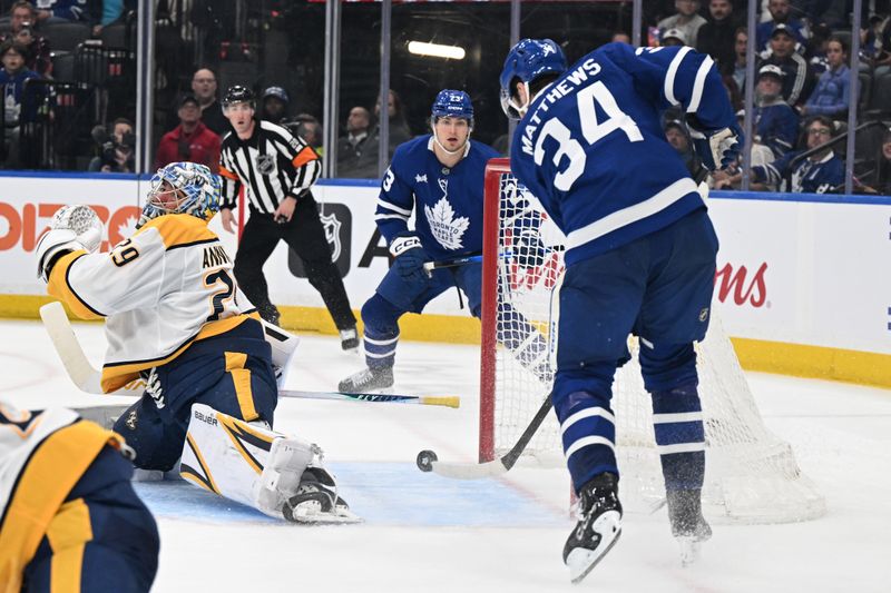 Oct 14, 2025; Toronto, Ontario, CAN;  Toronto Maple Leafs forward Auston Matthews (34) scores a goal past Nashville Predators goalie Justus Annunen (29) in the third period at Scotiabank Arena. Mandatory Credit: Dan Hamilton-Imagn Images