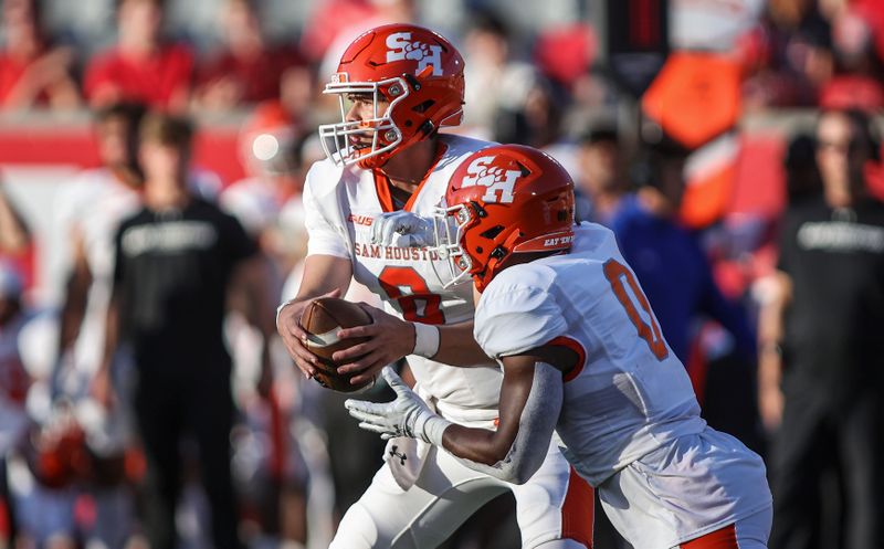 Sep 23, 2023; Houston, Texas, USA; Sam Houston State Bearkats quarterback Grant Gunnell (8) fakes a handoff to running back Zach Hrbacek (0) during the first quarter against the Houston Cougars at TDECU Stadium. Mandatory Credit: Troy Taormina-USA TODAY Sports