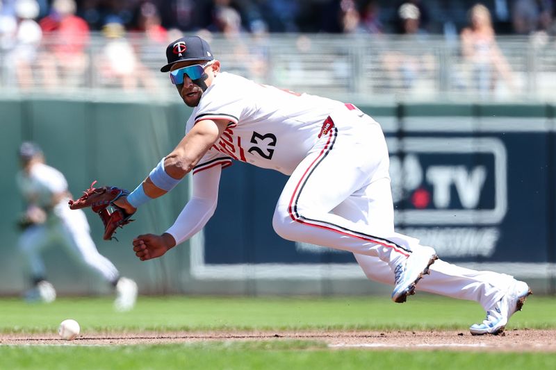 May 8, 2025; Minneapolis, Minnesota, USA; Minnesota Twins third baseman Royce Lewis (23) attempts to field the ball hit by Baltimore Orioles third baseman Emmanuel Rivera (26) during the second inning at Target Field. Mandatory Credit: Matt Krohn-Imagn Images