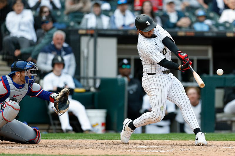 May 24, 2025; Chicago, Illinois, USA; Chicago White Sox second baseman Lenyn Sosa (50) hits a three-run double against the Texas Rangers during the sixth inning at Rate Field. Mandatory Credit: Kamil Krzaczynski-Imagn Images