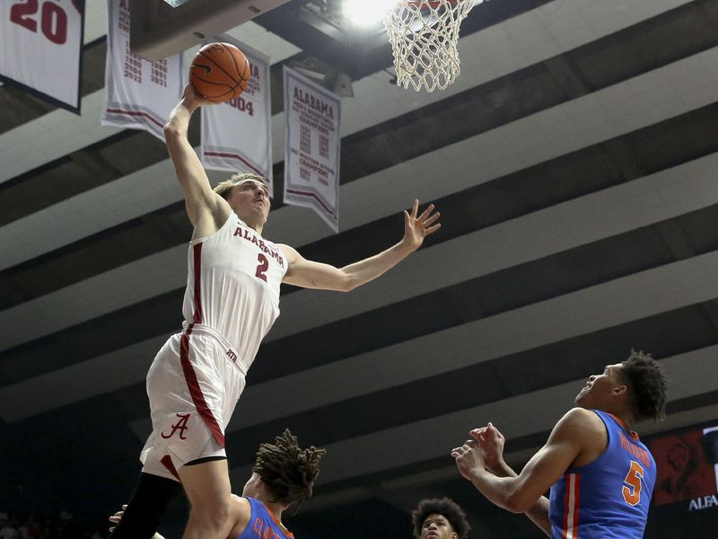 Feb 21, 2024; Tuscaloosa, Alabama, USA;  Alabama Crimson Tide forward Grant Nelson (2) dunks over Florida Gators guard Walter Clayton Jr. (1) at Coleman Coliseum. Mandatory Credit: Gary Cosby Jr.-USA TODAY Sports