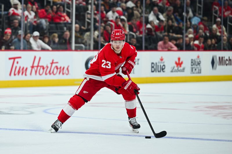 Nov 27, 2024; Detroit, Michigan, USA; Detroit Red Wings left wing Lucas Raymond (23) has the puck during the game against the Calgary Flames at Little Caesars Arena. Mandatory Credit: Tim Fuller-Imagn Images