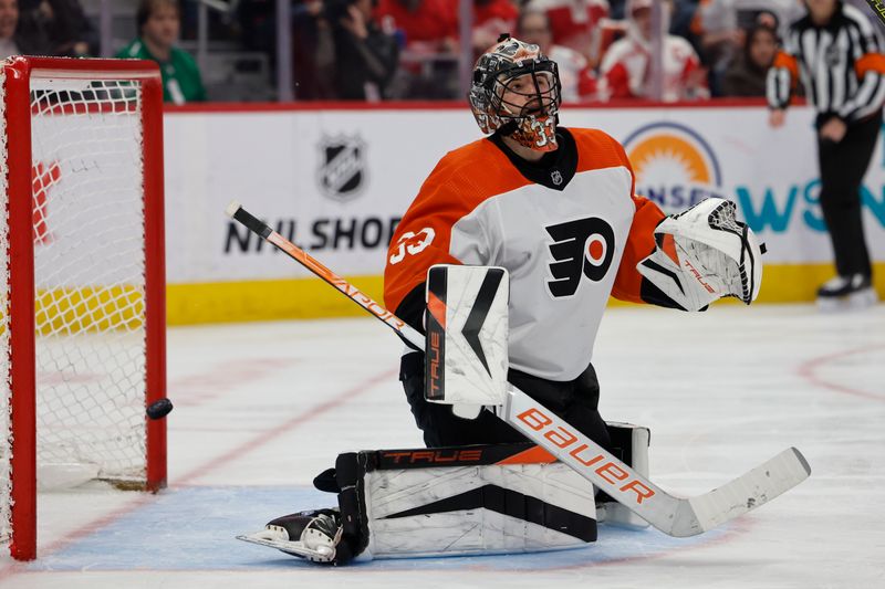 Jan 25, 2024; Detroit, Michigan, USA;  The puck gets past Philadelphia Flyers goaltender Samuel Ersson (33) for a goal in the second period against the Detroit Red Wings at Little Caesars Arena. Mandatory Credit: Rick Osentoski-USA TODAY Sports