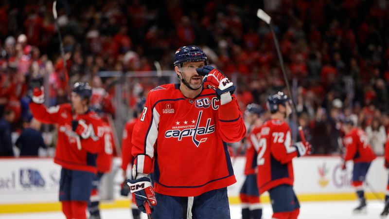 Mar 22, 2025; Washington, District of Columbia, USA; Washington Capitals left wing Alex Ovechkin (8) celebrates with his son in the stands after defeating the Florida Panthers at Capital One Arena. Mandatory Credit: Amber Searls-Imagn Images
