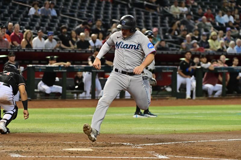 May 8, 2023; Phoenix, Arizona, USA;  Miami Marlins catcher Nick Fortes (4) scores in the fifth inning against the Arizona Diamondbacks at Chase Field. Mandatory Credit: Matt Kartozian-USA TODAY Sports