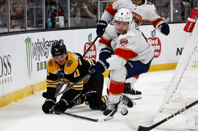 Mar 11, 2025; Boston, Massachusetts, USA; Florida Panthers center Nico Sturm (8) goes for a loose puck in front of fallen Boston Bruins center Casey Mittelstadt (11) during the first period at TD Garden. Mandatory Credit: Winslow Townson-Imagn Images