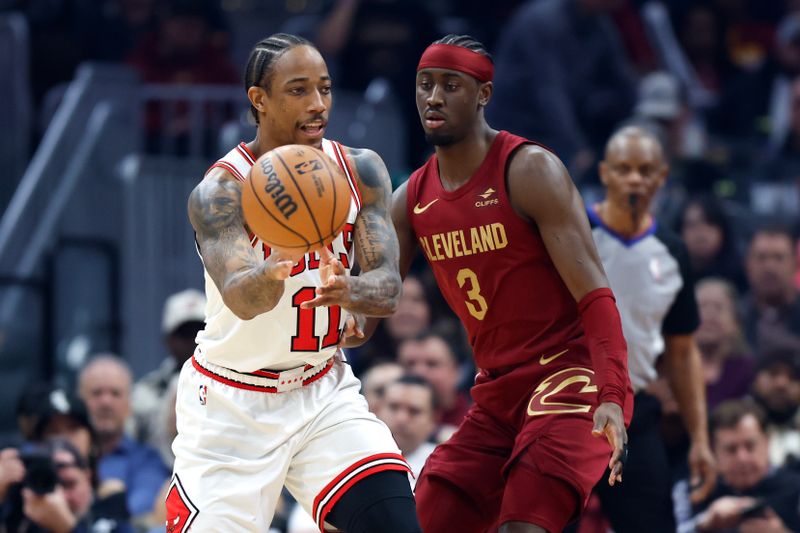 CLEVELAND, OH - FEBRUARY 14: DeMar DeRozan #11 of the Chicago Bulls passes against Caris LeVert #3 of the Cleveland Cavaliers during the first half at Rocket Mortgage Fieldhouse on February 14, 2024 in Cleveland, Ohio. NOTE TO USER: User expressly acknowledges and agrees that, by downloading and or using this photograph, User is consenting to the terms and conditions of the Getty Images License Agreement. (Photo by Ron Schwane/Getty Images)