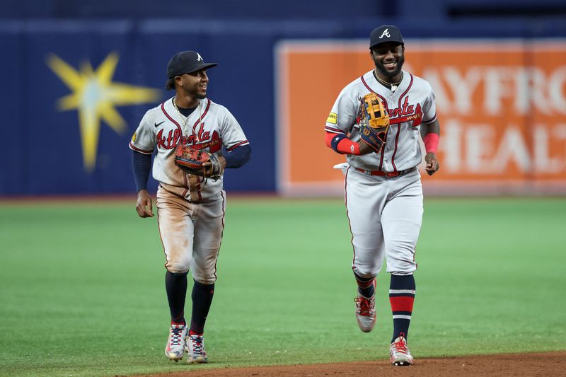 Jul 8, 2023; St. Petersburg, Florida, USA;  Atlanta Braves second baseman Ozzie Albies (1) and center fielder Michael Harris II (23) leave the field against the Tampa Bay Rays in the eighth inning at Tropicana Field. Mandatory Credit: Nathan Ray Seebeck-USA TODAY Sports