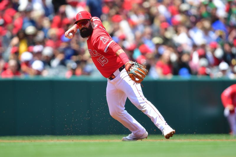 May 26, 2024; Anaheim, California, USA; Los Angeles Angels second base Luis Guillorme (15) throws to first for the out against Cleveland Guardians outfielder Tyler Freeman (2) during the third inning at Angel Stadium. Mandatory Credit: Gary A. Vasquez-USA TODAY Sports