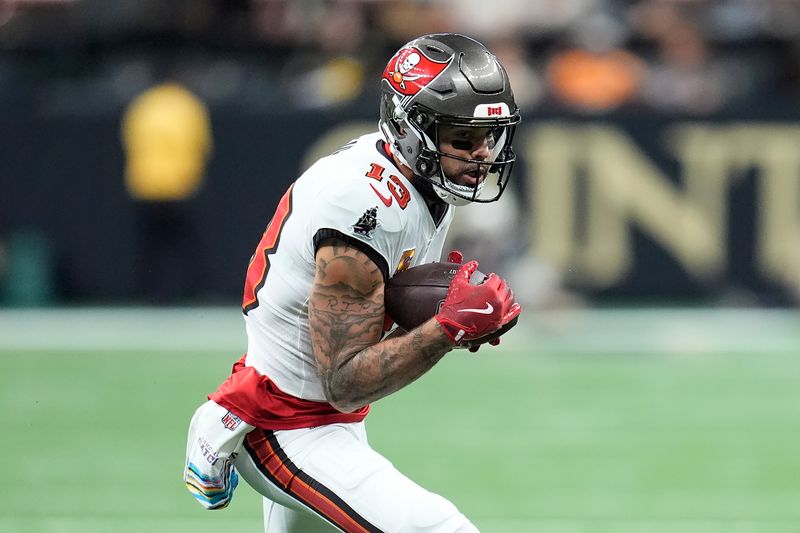 Tampa Bay Buccaneers wide receiver Mike Evans (13) runs against the New Orleans Saints during the first half of an NFL football game in New Orleans, Sunday, Oct. 13, 2024. (AP Photo/Michael Conroy)