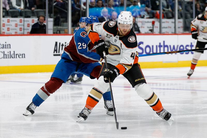 Dec 5, 2023; Denver, Colorado, USA; Anaheim Ducks defenseman Cam Fowler (4) controls the puck ahead of Colorado Avalanche center Nathan MacKinnon (29) in the second period at Ball Arena. Mandatory Credit: Isaiah J. Downing-USA TODAY Sports